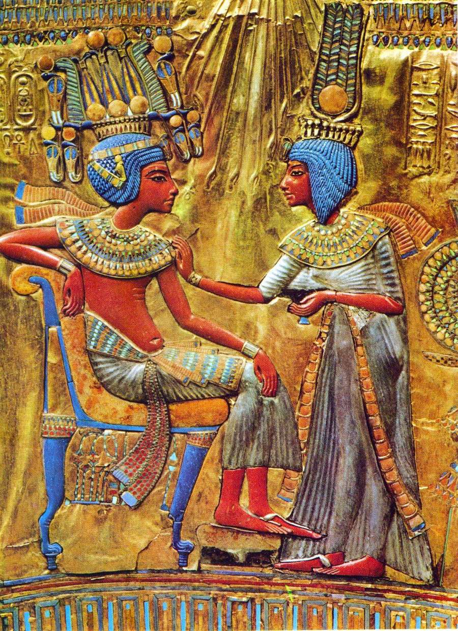 An ancient Egyptian artwork depicting two figures, a seated person receiving an anointing from a standing figure. Their attire and surrounding hieroglyphs highlight traditional Egyptian styles and symbols.