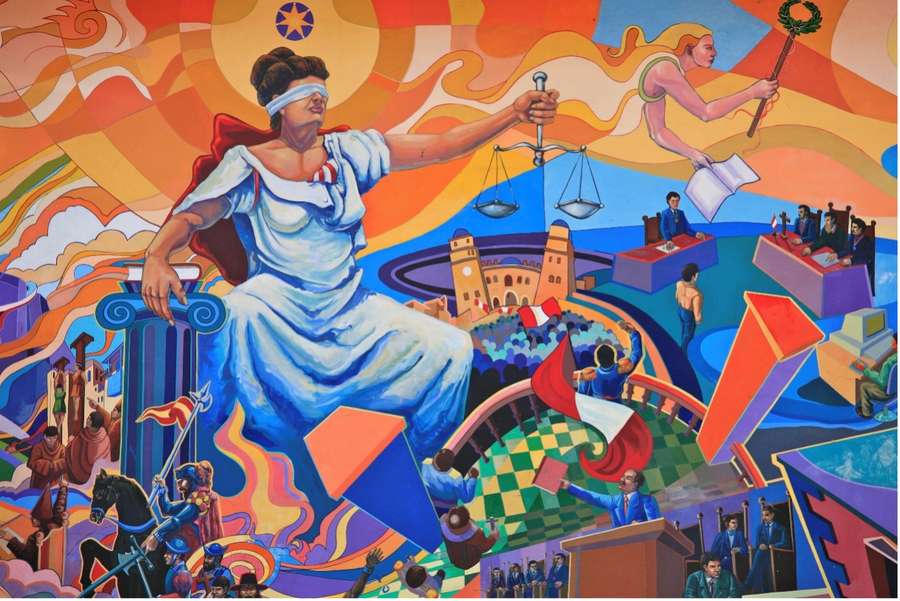 A vibrant mural of a woman in a white dress, holding a scale, amidst a bustling cityscape with various figures and symbols.